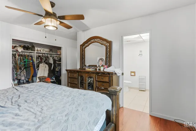 a bed room with a bed and a large mirror