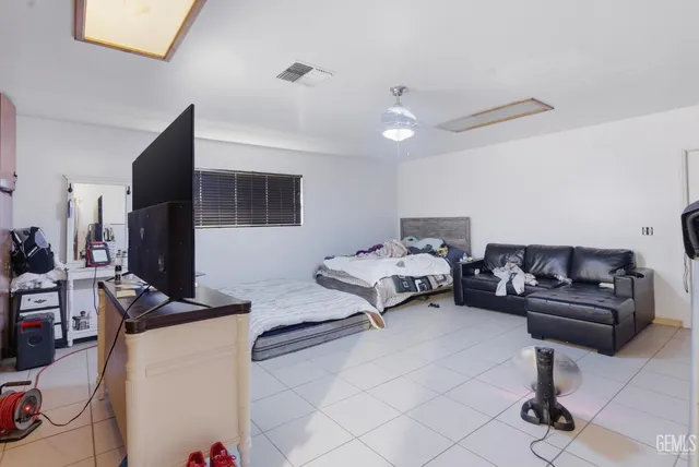 a bedroom with furniture and a flat screen tv