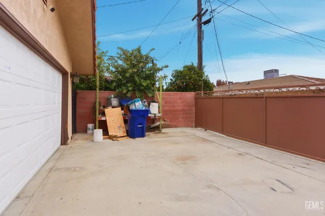 a view of a terrace with lawn chairs