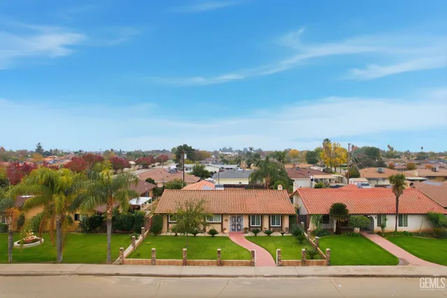 an aerial view of a house with a yard