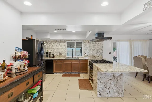 a kitchen with stainless steel appliances a stove top oven and cabinets