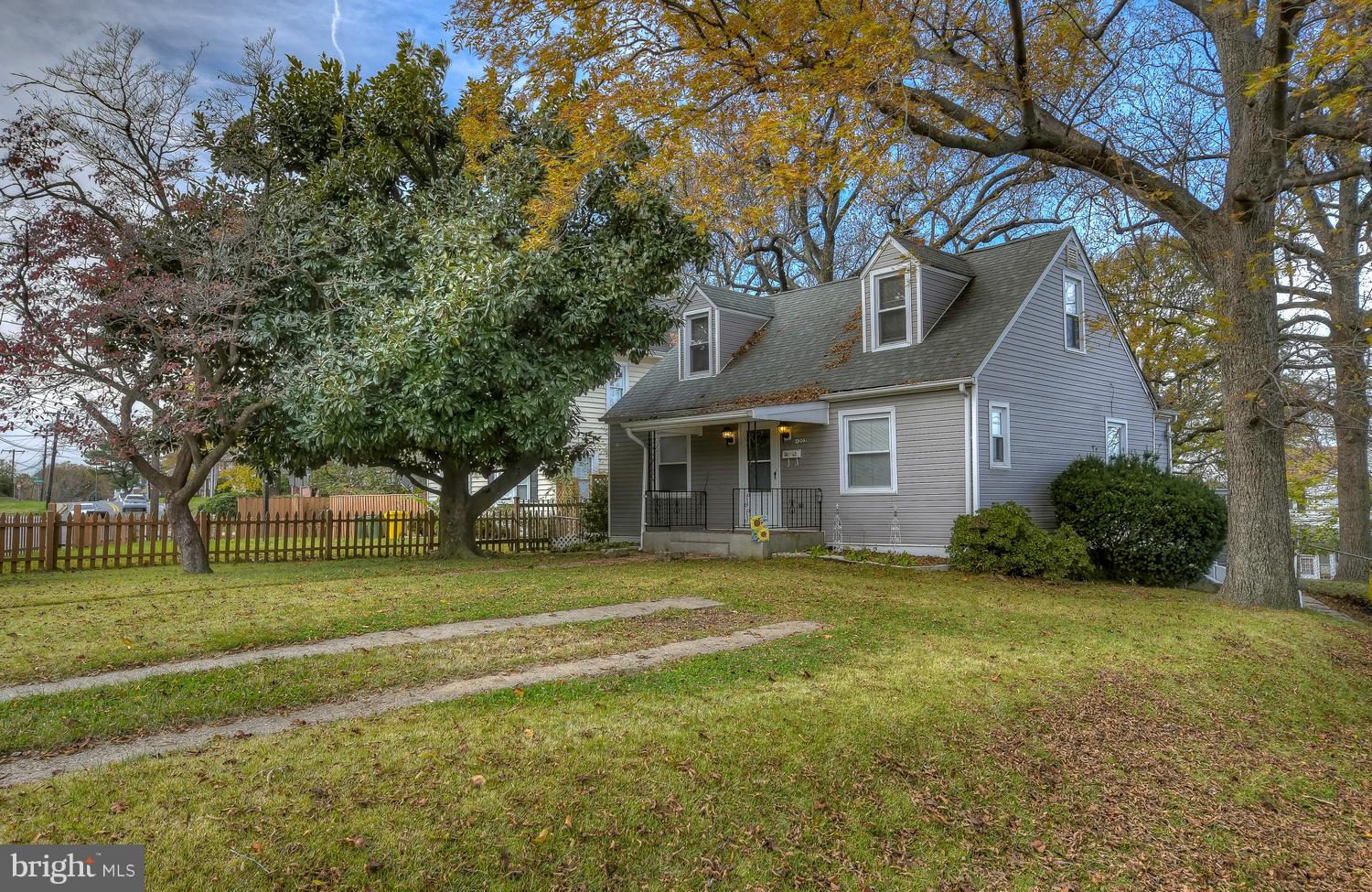 4202 Belle Grove Road Baltimore, MD 21225 - Photo 2 of 31 a view of a house with a big yard and large trees