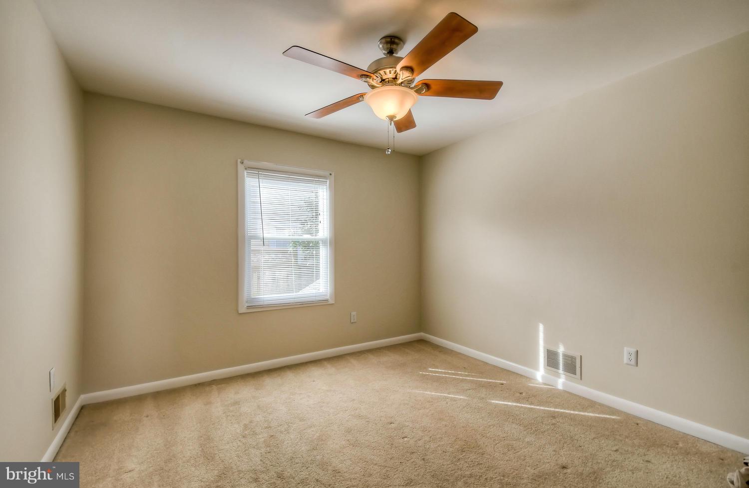 4202 Belle Grove Road Baltimore, MD 21225 - Photo 15 of 31 an empty room with a ceiling fan and window