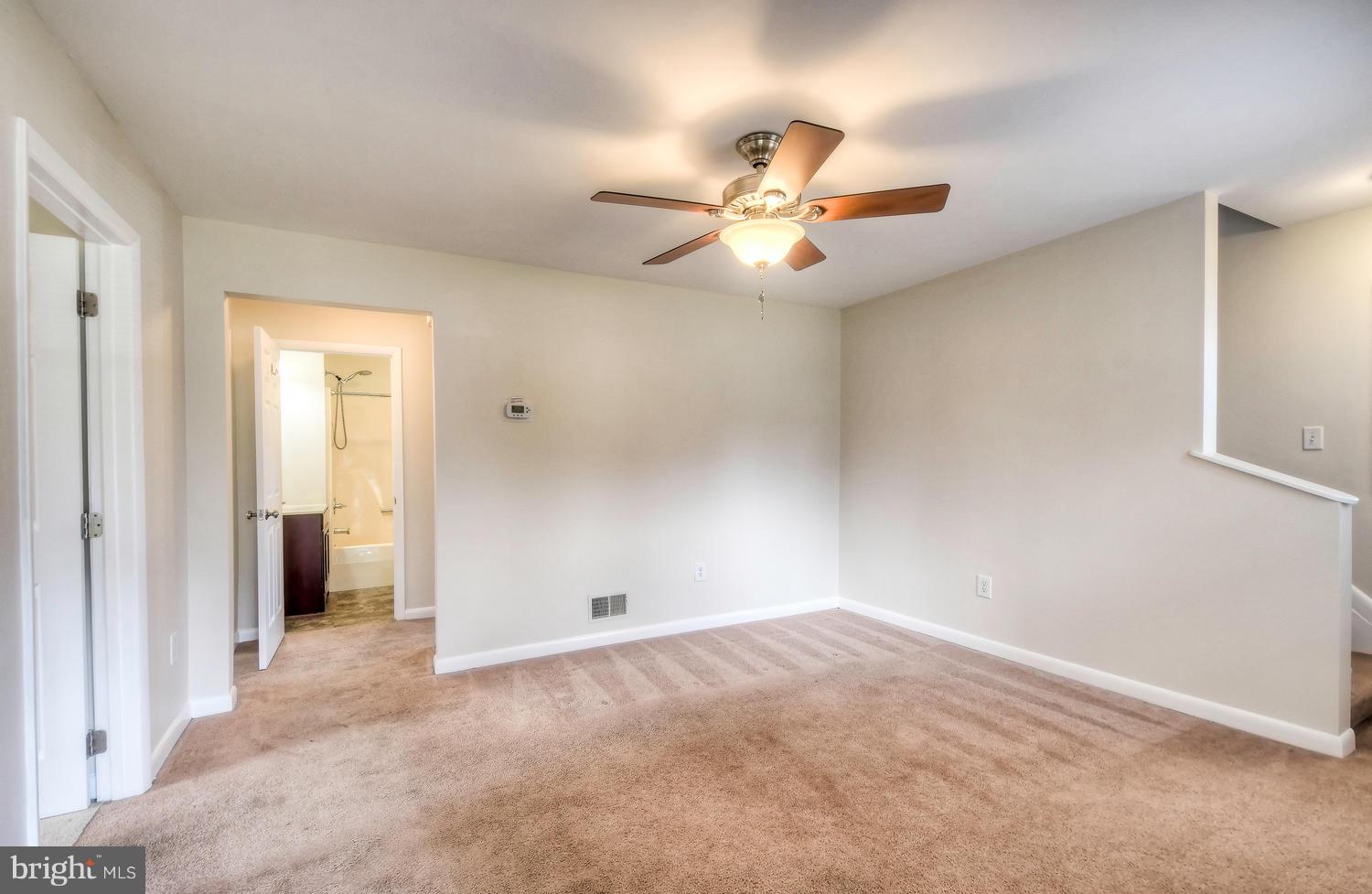 4202 Belle Grove Road Baltimore, MD 21225 - Photo 6 of 31 an empty room with closet and a ceiling fan