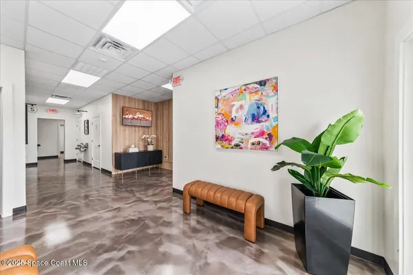 a view of a entryway with furniture and a potted plant