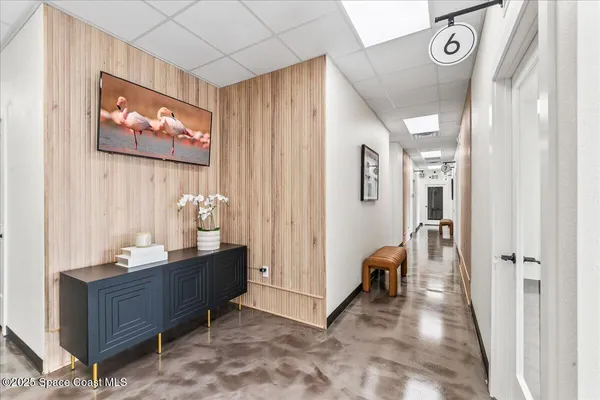 a view of a hallway with bathroom and front door