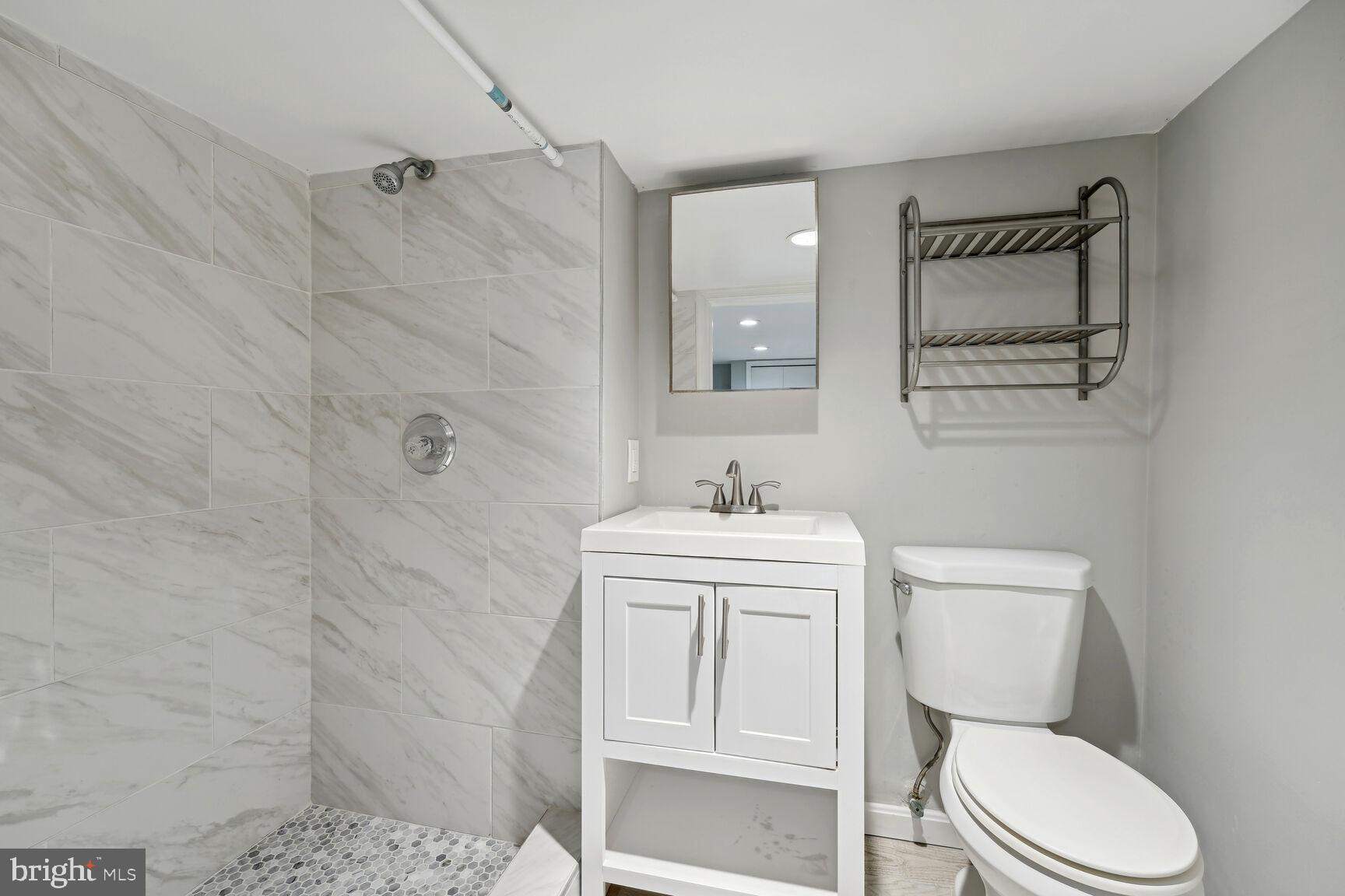 768 Quebec Place Northwest, Unit C Washington, DC 20010 - Photo 11 of 13 a bathroom with a toilet sink and mirror