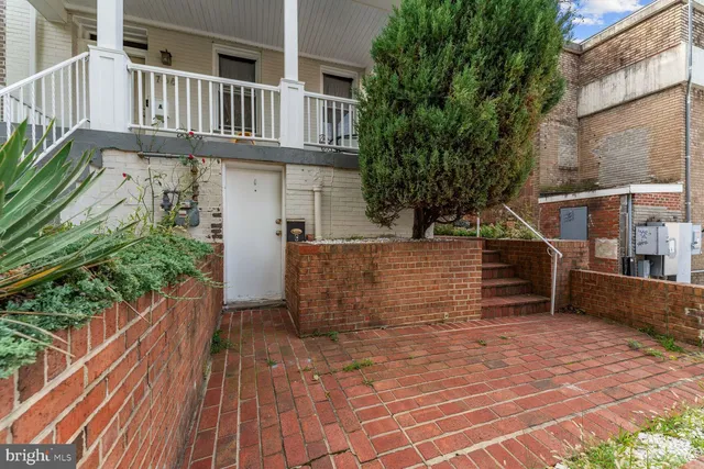 a view of entryway with wooden floor and fence