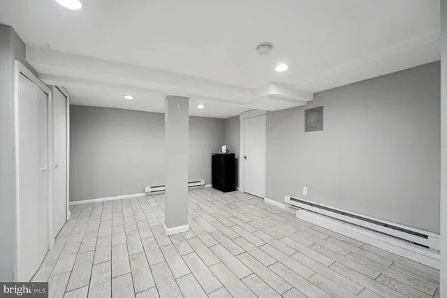 a view of an empty room with wooden floor