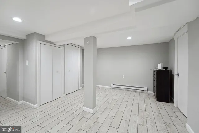 a view of empty room with wooden floor