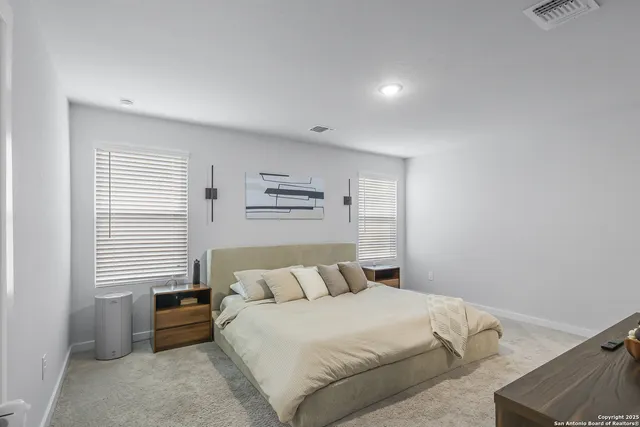 a bedroom with a bed and a couch