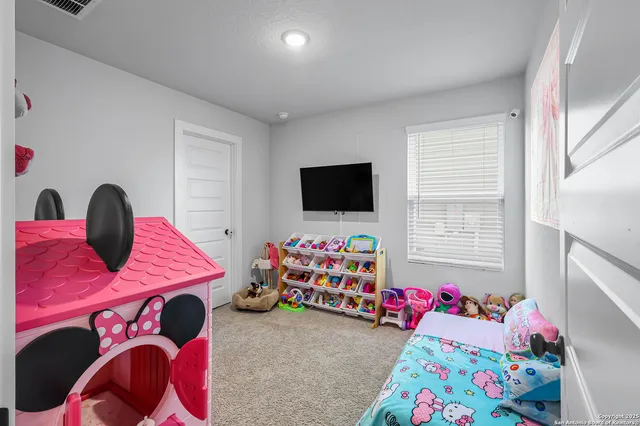 a bedroom with two beds and a window