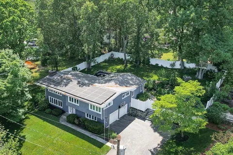 aerial view of a house with swimming pool and a yard