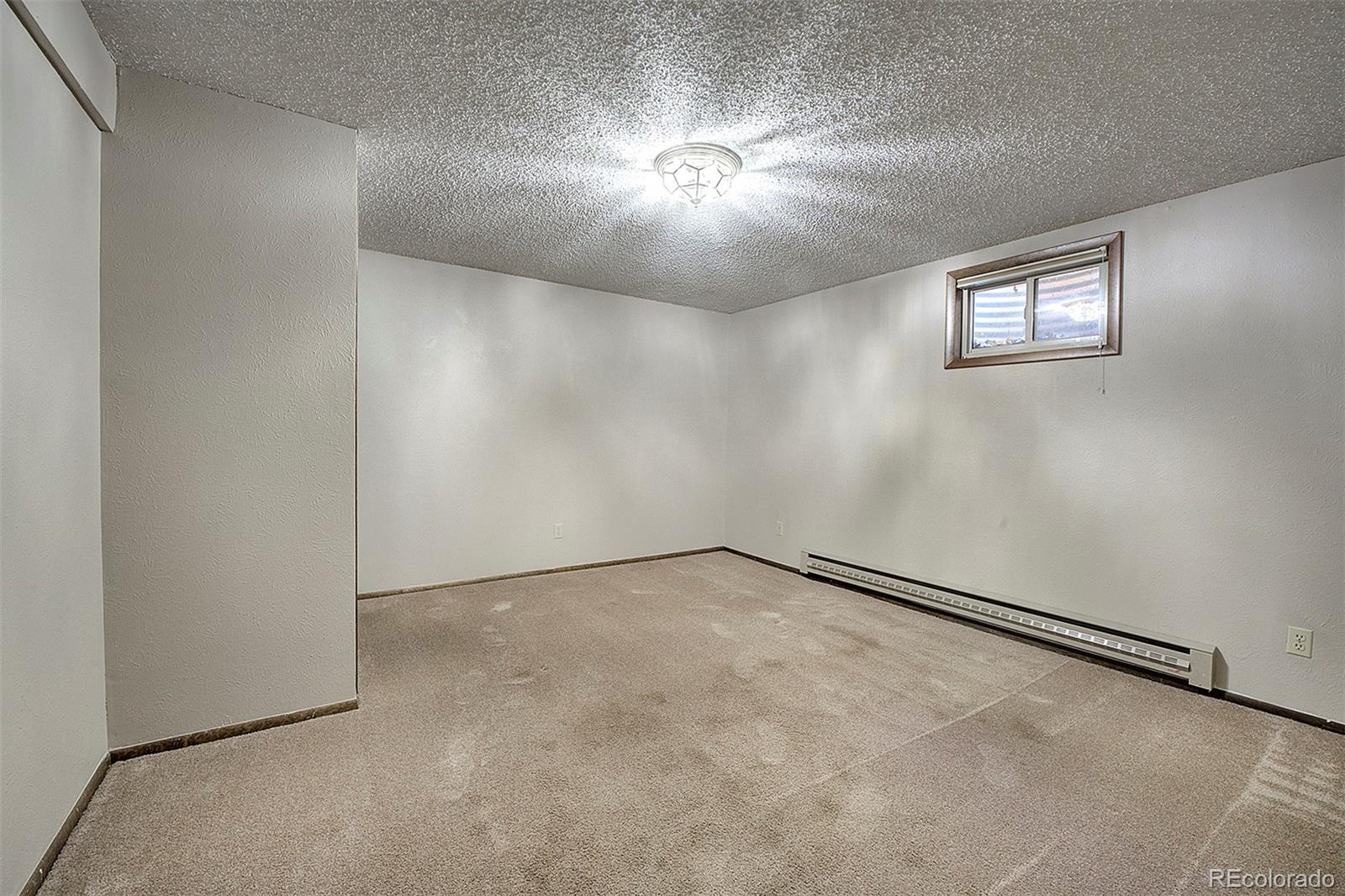 6561 Ridgeview Drive Morrison, CO 80465 - Photo 24 of 36 an empty room with windows and closet