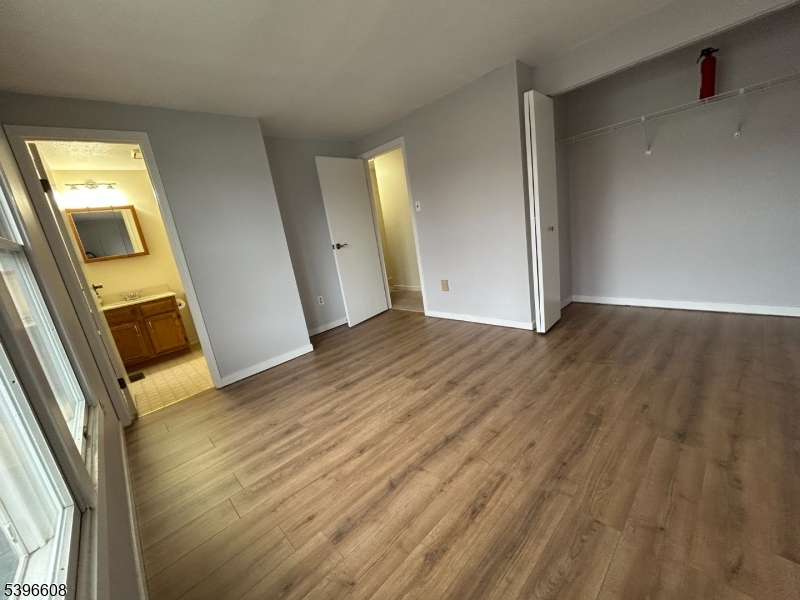 40 Constitution Way Franklin, NJ 07416 - Photo 11 of 13 a view of an empty room with wooden floor and a window