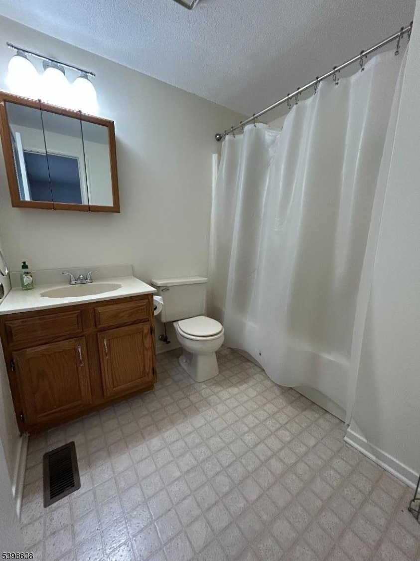 40 Constitution Way Franklin, NJ 07416 - Photo 13 of 13 a bathroom with a sink a toilet and a mirror