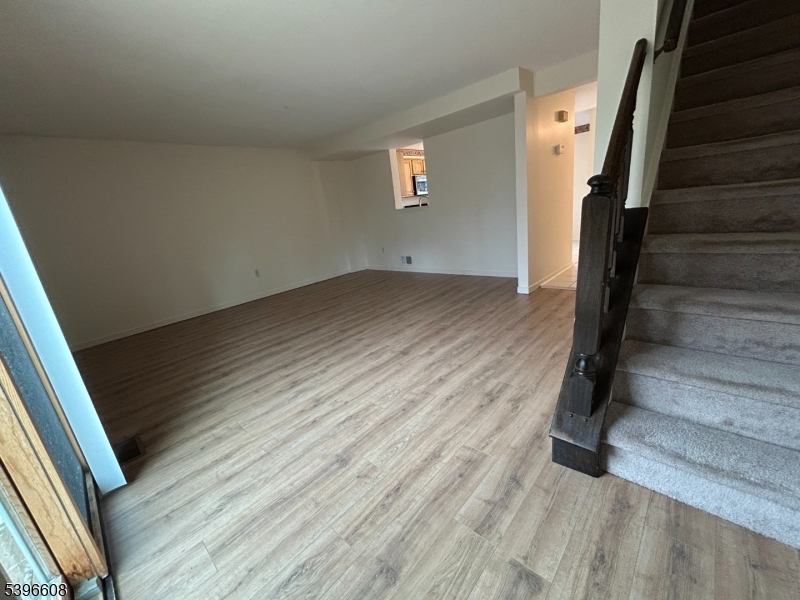 40 Constitution Way Franklin, NJ 07416 - Photo 5 of 13 a view of a hallway with wooden floor and staircase