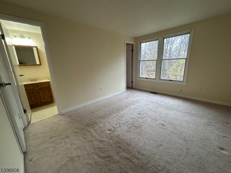40 Constitution Way Franklin, NJ 07416 - Photo 6 of 13 a view of an empty room with a fireplace and a window