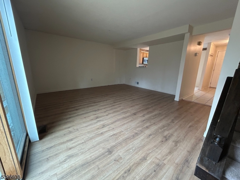 40 Constitution Way Franklin, NJ 07416 - Photo 7 of 13 an empty room with wooden floor and entrance