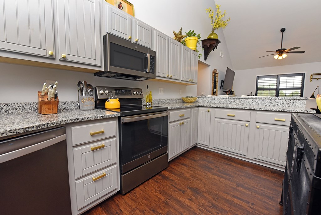 54 Linda Lane Blue Ridge, GA 30513 - Photo 6 of 59 a kitchen with granite countertop wooden cabinets stainless steel appliances and a window