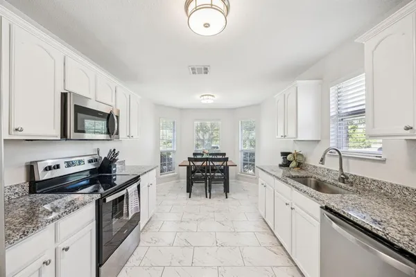 a kitchen with a sink stove and microwave