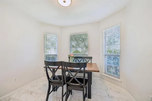 a dining room with furniture and window