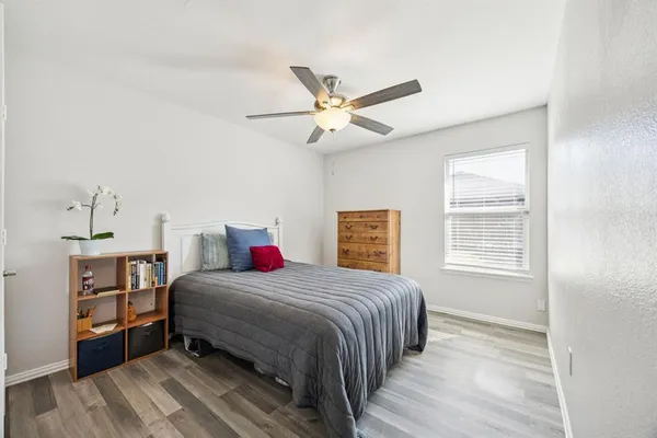 a bedroom with a bed and dresser