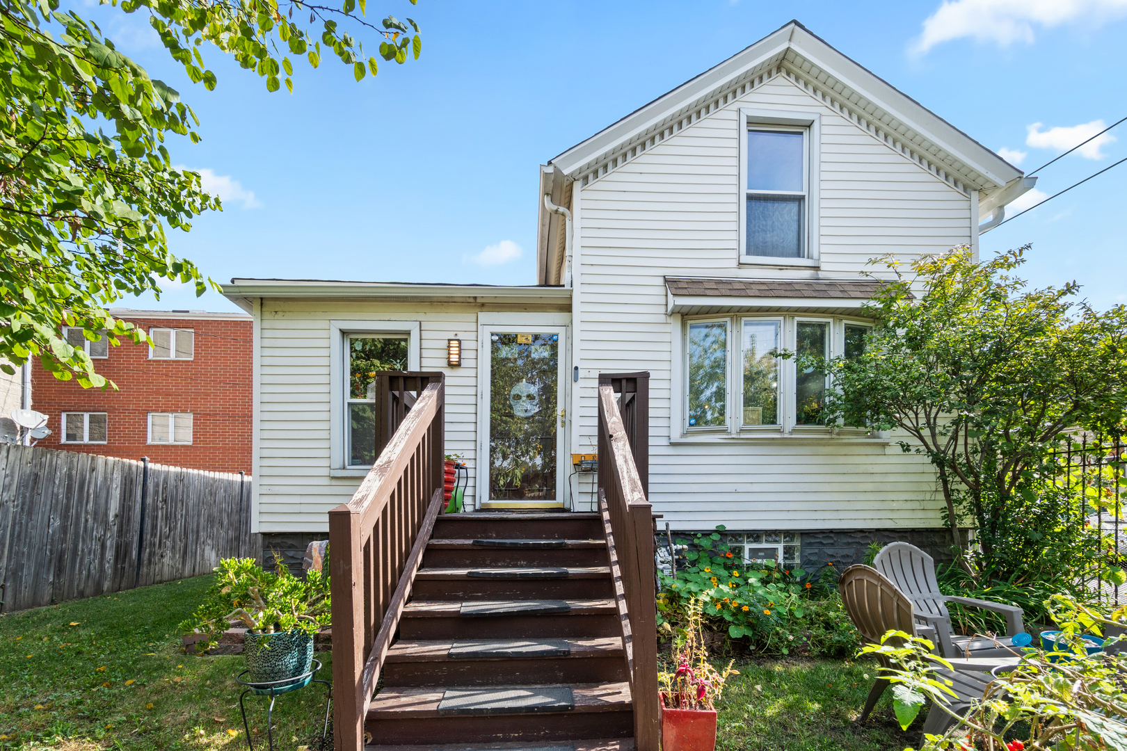 a front view of a house with a garden