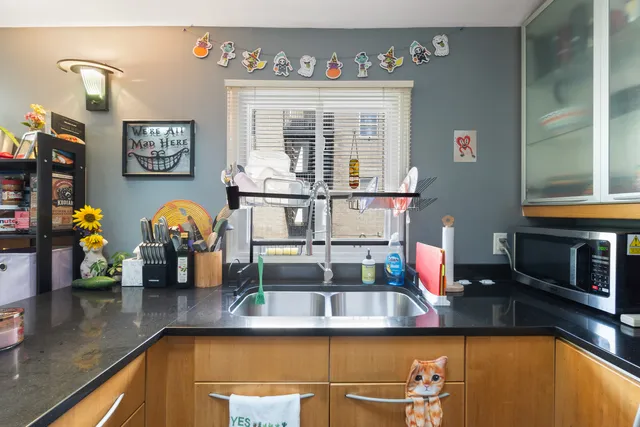 a view of a hallway with wooden floor and stairs