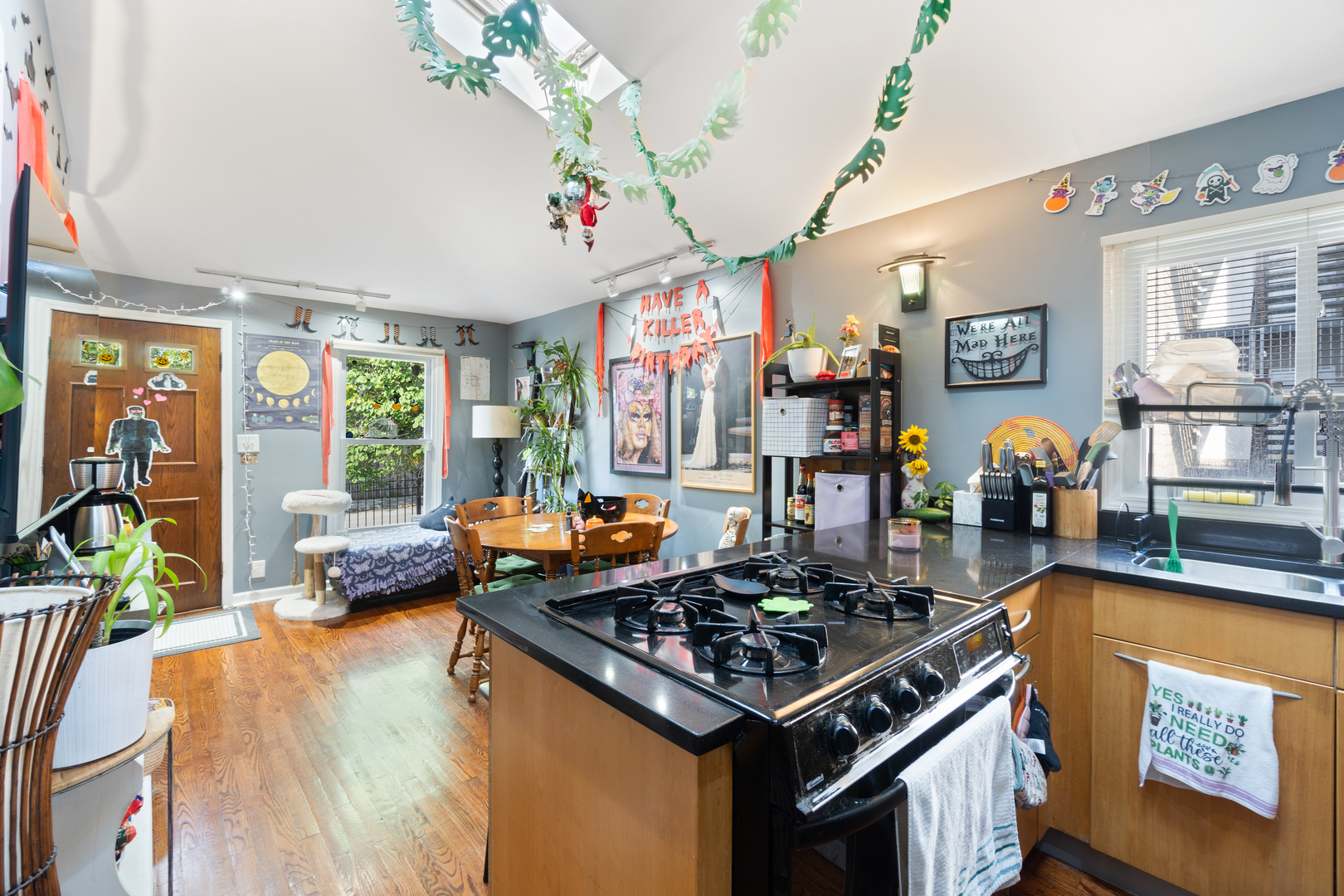 1111 South Campbell Avenue Chicago, IL 60612 - Photo 16 of 28 a kitchen filled with a stove a flat screen tv and a large window