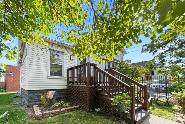a balcony with flower plants in front of house