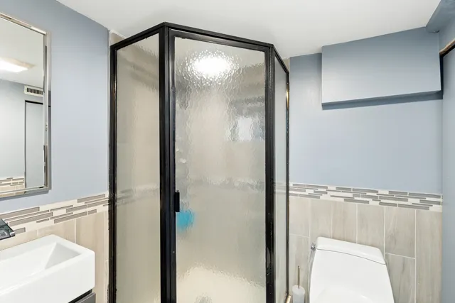 a bathroom with a sink a bathtub and a window