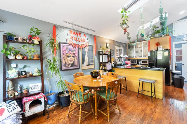 a dining room with furniture and wooden floor