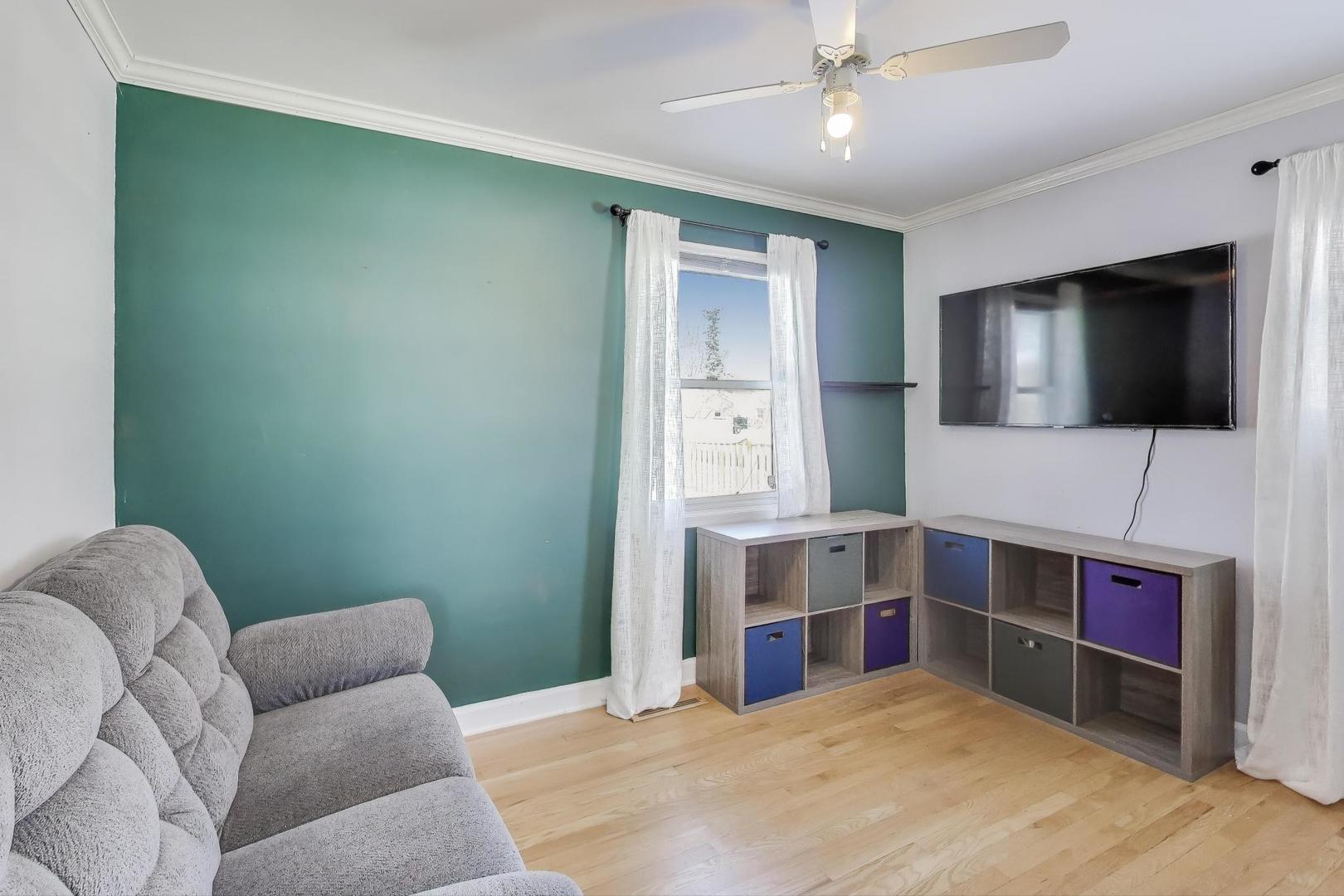 218 North School Street Mount Prospect, IL 60056 - Photo 11 of 30 a bedroom with furniture and a flat screen tv