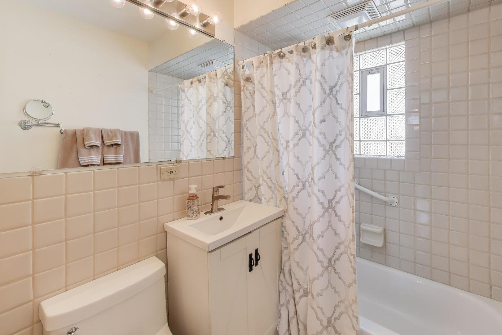 218 North School Street Mount Prospect, IL 60056 - Photo 14 of 30 a bathroom with a sink a toilet and shower