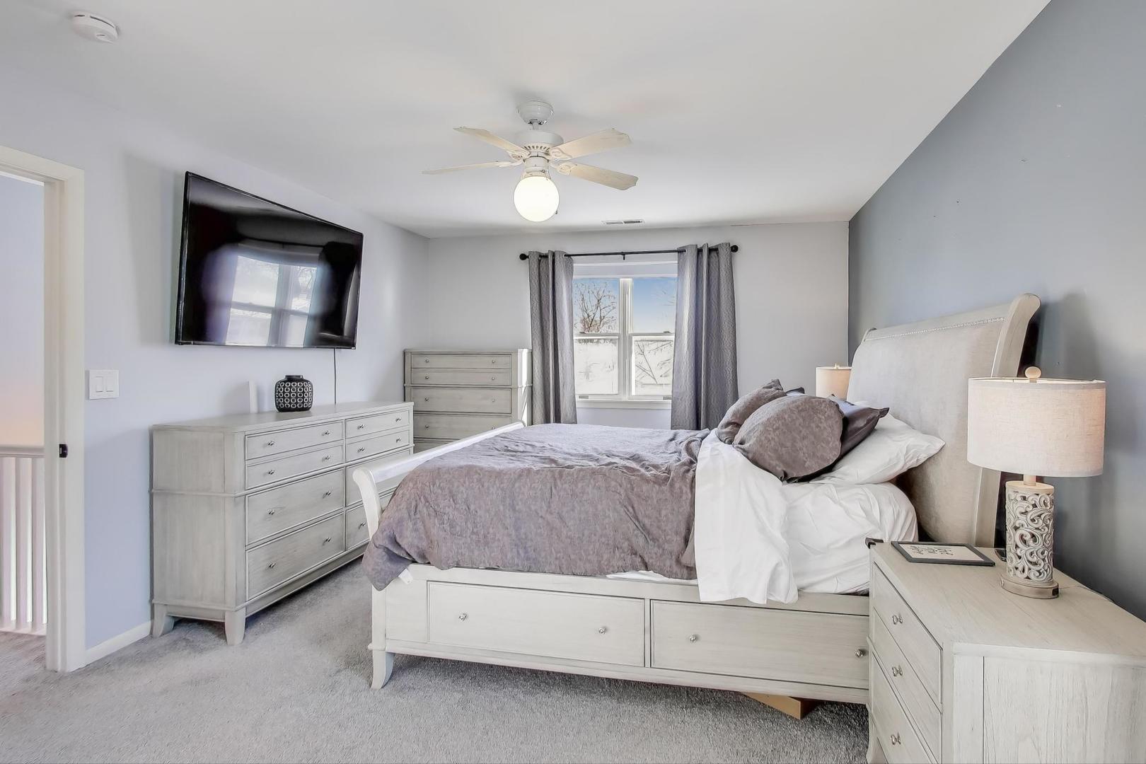 218 North School Street Mount Prospect, IL 60056 - Photo 15 of 30 a bedroom with a bed and a flat screen tv