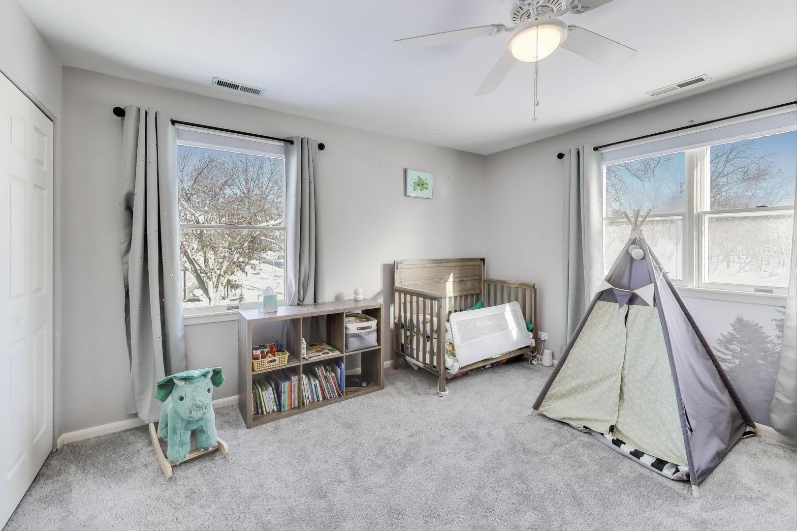 218 North School Street Mount Prospect, IL 60056 - Photo 20 of 30 a bed room with a bed and a chandelier