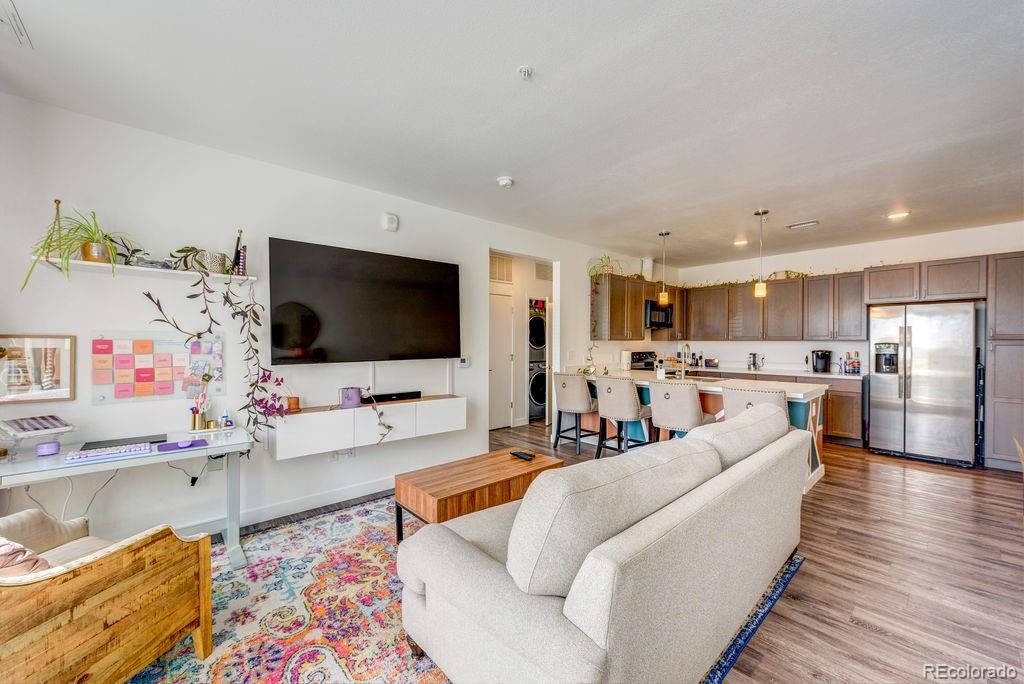 8475 East 36th Avenue, Unit 241 Denver, CO 80238 - Photo 2 of 11 a living room with furniture and a flat screen tv