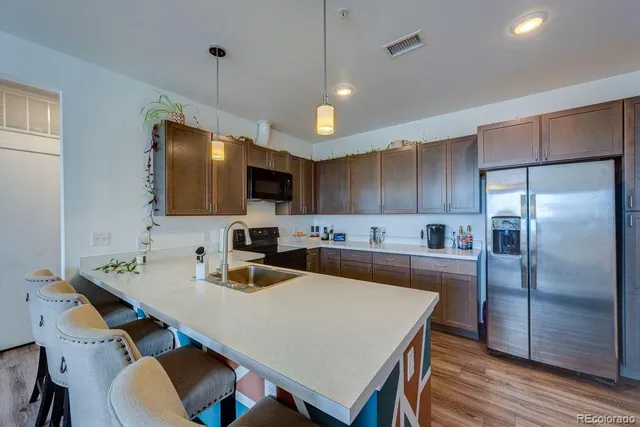 a kitchen with refrigerator cabinets and wooden floor
