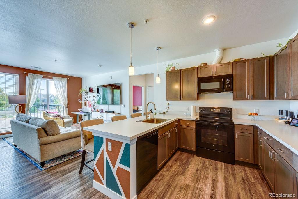 8475 East 36th Avenue, Unit 241 Denver, CO 80238 - Photo 4 of 11 a kitchen with stainless steel appliances granite countertop a sink stove and refrigerator
