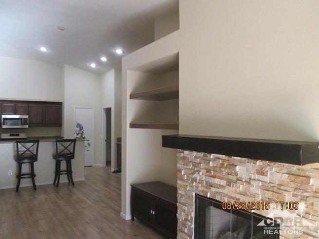 41643 Petersfield Road Bermuda Dunes, CA 92203 - Photo 5 of 29 a living room with stainless steel appliances furniture a fireplace and a flat screen tv