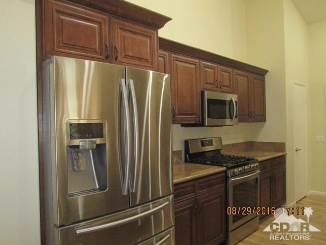 41643 Petersfield Road Bermuda Dunes, CA 92203 - Photo 7 of 29 a kitchen with stainless steel appliances granite countertop a refrigerator and a stove top oven