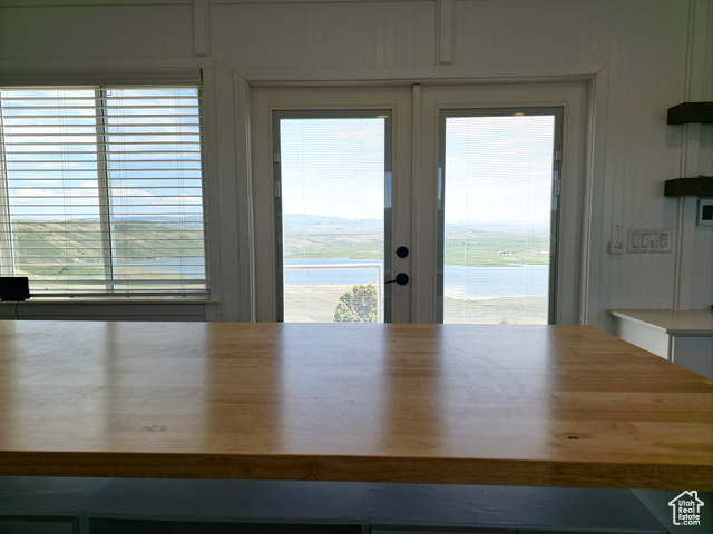 900 Altamont Road Evanston, WY 82930 - Photo 6 of 27 Unfurnished dining area featuring a water view and french doors