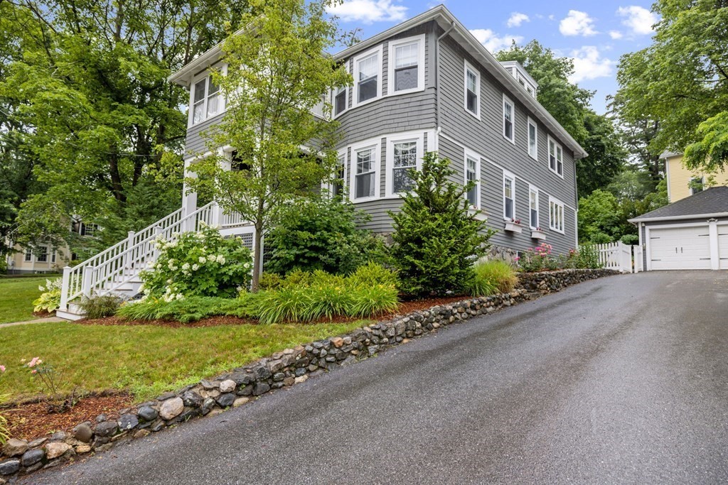 5 Belfry Terrace Lexington, MA 02421 - Photo 1 of 40 a front view of a house with a yard and a garage