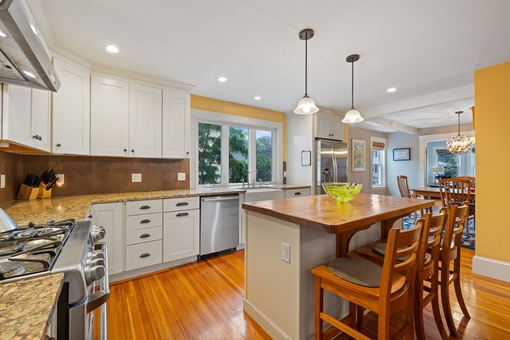 5 Belfry Terrace Lexington, MA 02421 - Photo 12 of 40 a kitchen with a stove a sink a counter space and dining table