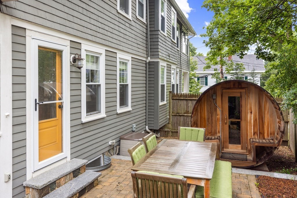 5 Belfry Terrace Lexington, MA 02421 - Photo 36 of 40 a view of deck with a table and chairs and wooden fence