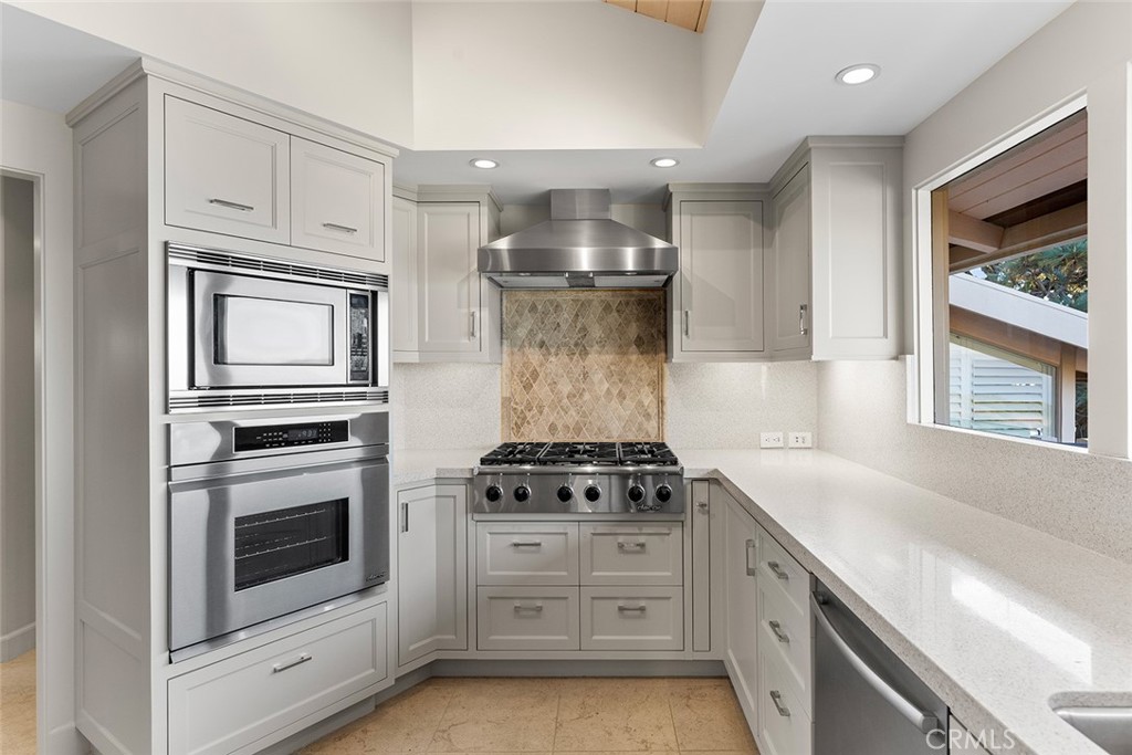 1503 Emerald Bay Laguna Beach, CA 92651 - Photo 16 of 32 a kitchen with white cabinets and appliances