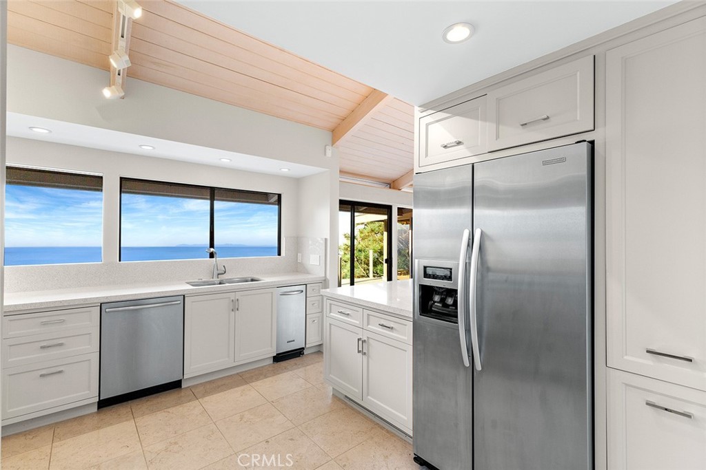 1503 Emerald Bay Laguna Beach, CA 92651 - Photo 17 of 32 a kitchen with a refrigerator and a sink