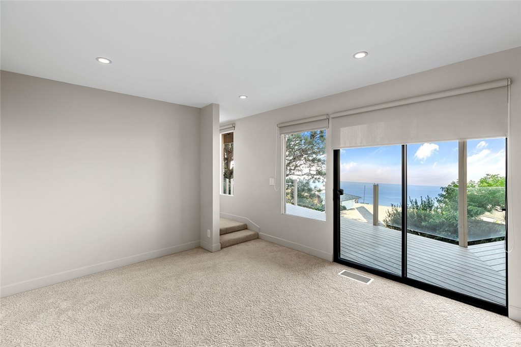 1503 Emerald Bay Laguna Beach, CA 92651 - Photo 22 of 32 an empty room with sliding door and windows