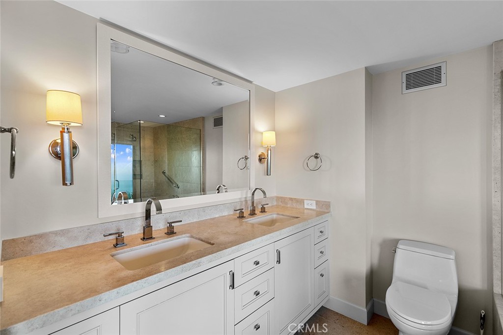 1503 Emerald Bay Laguna Beach, CA 92651 - Photo 24 of 32 a bathroom with a toilet a sink a mirror and vanity